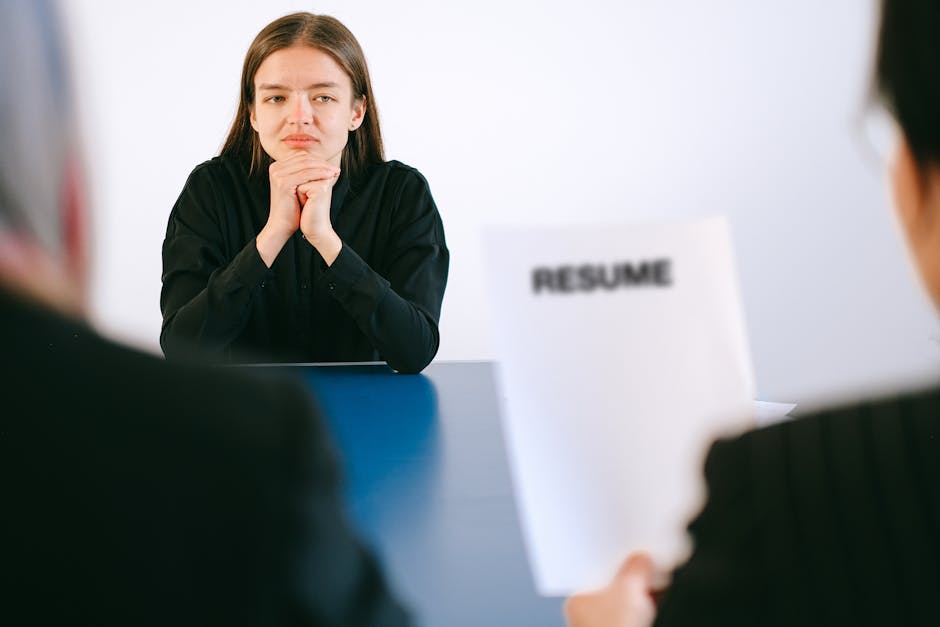 A woman in a job interview facing two employers wi