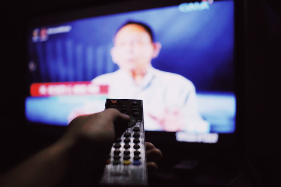 Crop anonymous person with remote controller switc