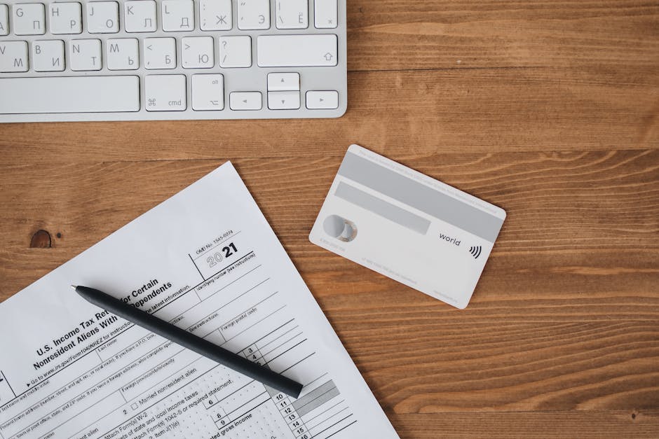 Overhead view of a desk with tax form pen keyboa