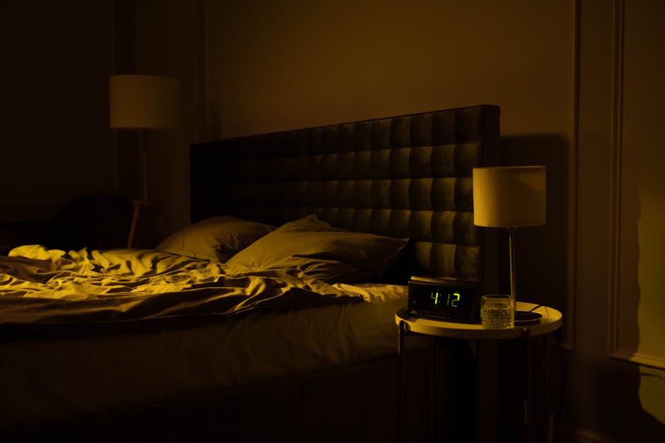 Relaxing dimly lit bedroom with an unmade bed dig