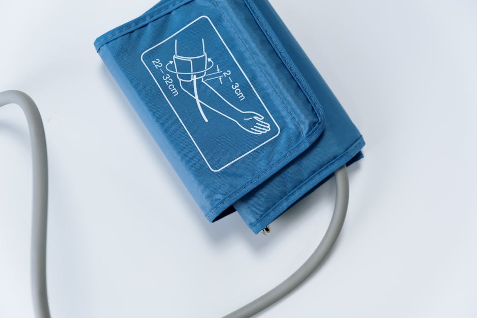 Close up of a blue blood pressure cuff on a white