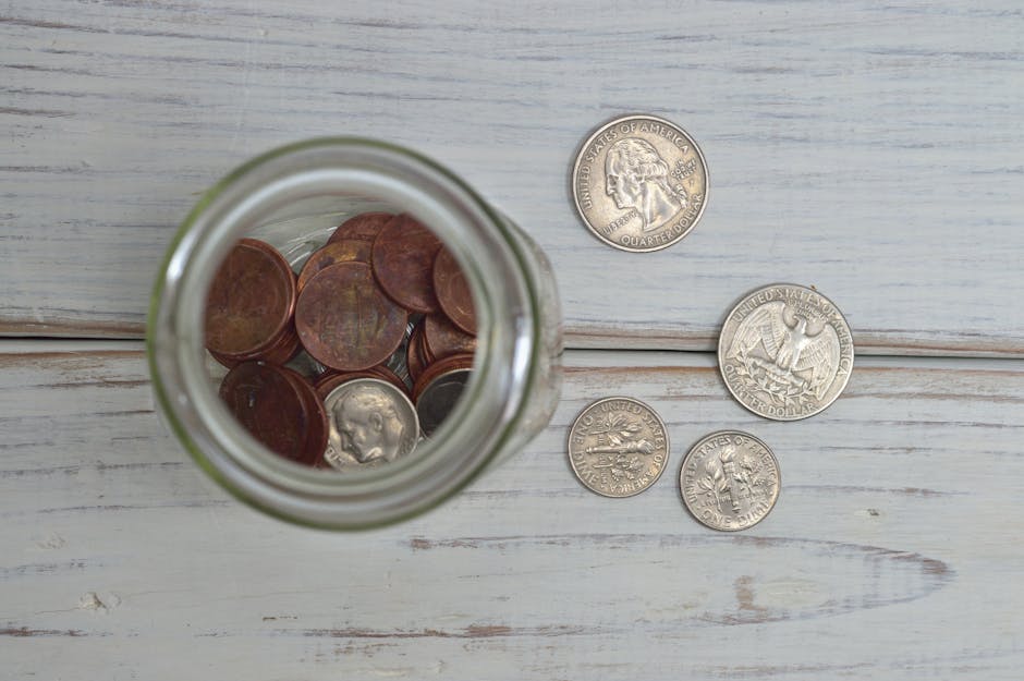 Top view of a jar filled with coins placed on a wo
